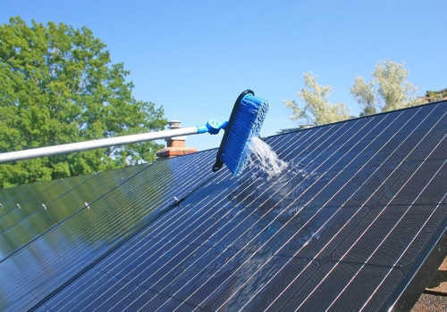 What type of cleaning cloth should be used on solar panels?